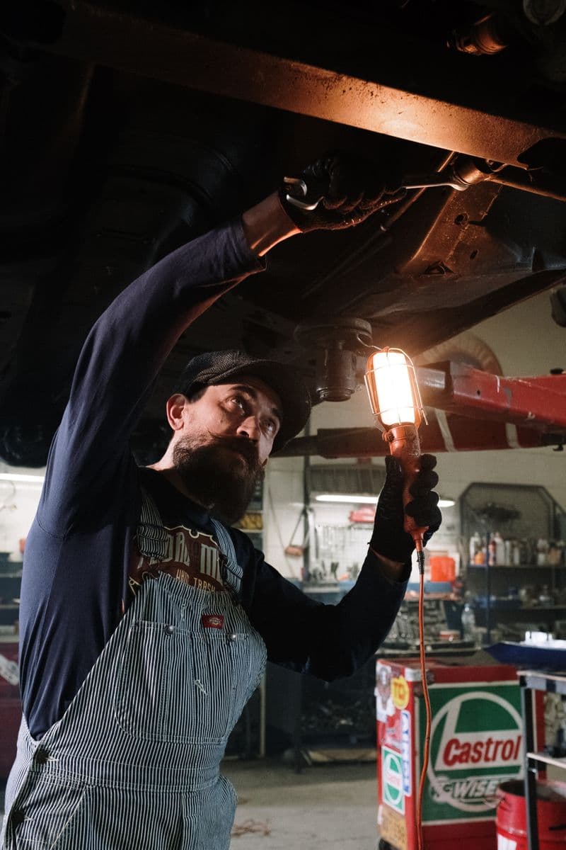 Mechanic inspecting vehicle brake components